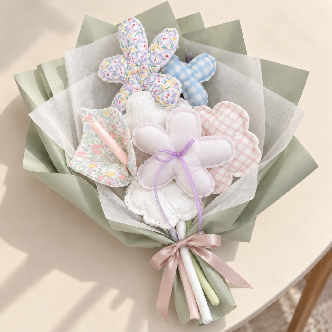 Lilac Keepsake fabric bouquet styled with sage paper and tissue wrap; presentation styling only