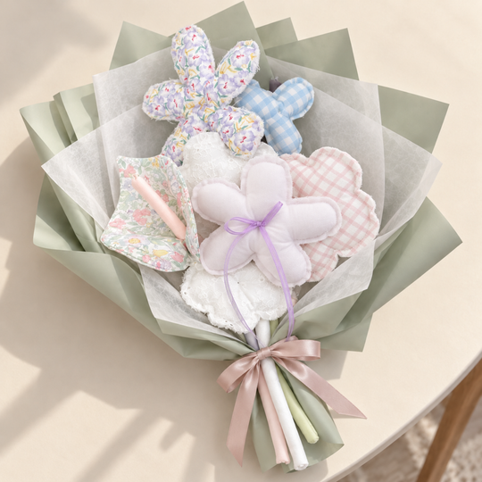 Lilac Keepsake fabric bouquet styled with sage paper and tissue wrap; presentation styling only